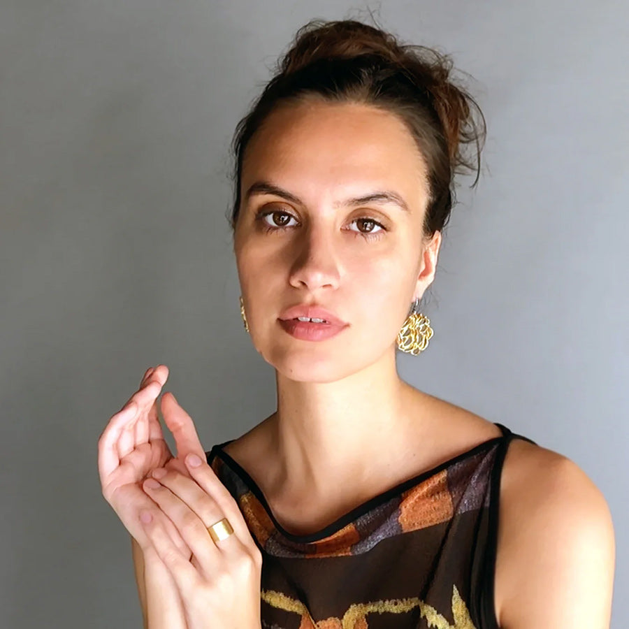 Model wearing Banksia Medallion Earrings by Kirsten Muenster