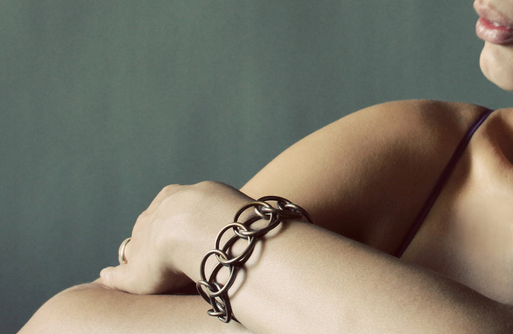 Model's hand enclosed In Half Persian Chain Bracelet for KMJ lookbook