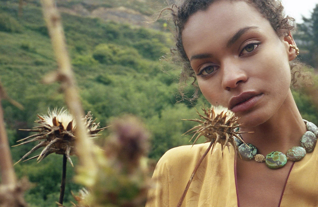 Model wearing Tibetan Turquoise Necklace for lookbook in a natural setting